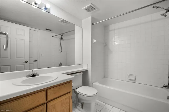 a bathroom with a sink toilet vanity and shower