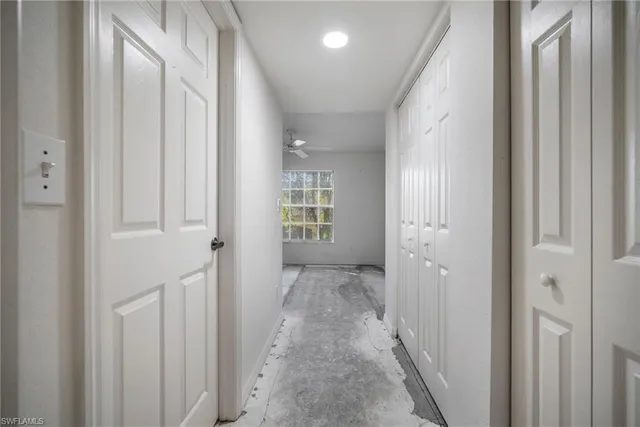 a view of a hallway with wooden floor and entryway