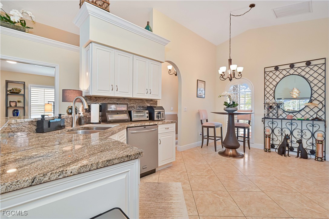 21593 Windham Run Estero, FL 33928 - Photo 12 of 49 a kitchen with stainless steel appliances granite countertop a stove a sink and a refrigerator