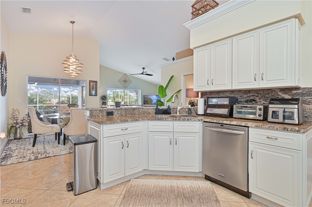 21593 Windham Run Estero, FL 33928 - Photo 14 of 49 a kitchen with a white cabinets and chairs