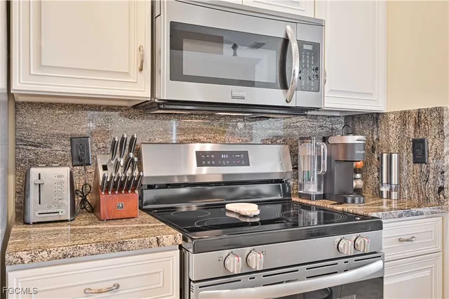 a stove top oven sitting inside of a kitchen