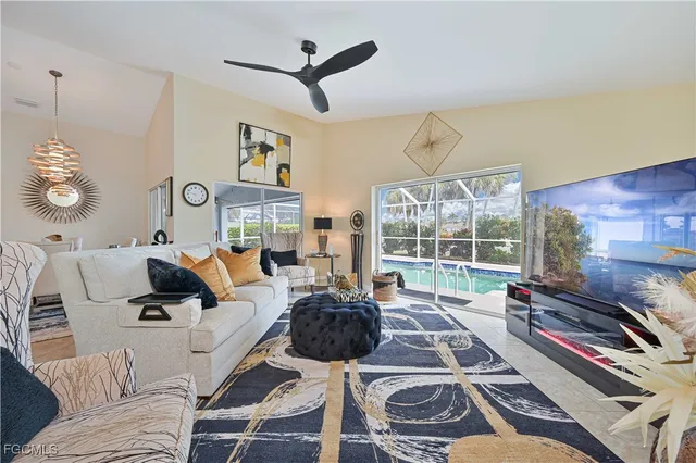 a living room with furniture a flat screen tv and a large window