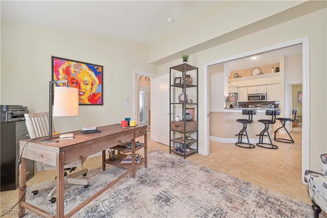a room with furniture a rug and white walls