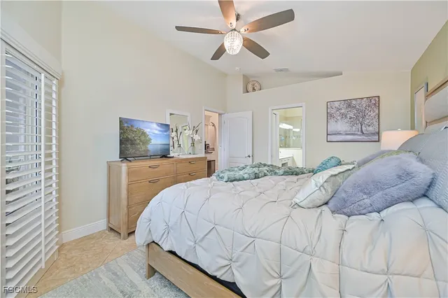 a bedroom with a large bed and a chandelier