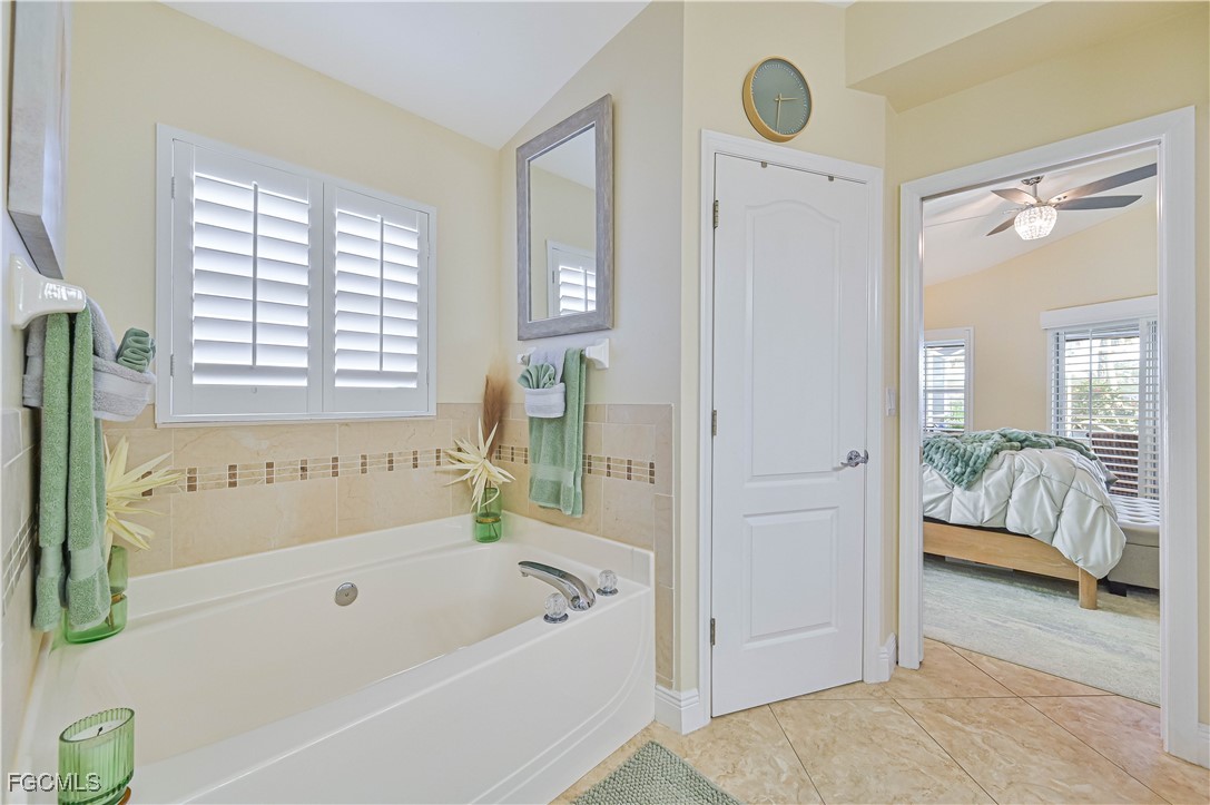 21593 Windham Run Estero, FL 33928 - Photo 30 of 49 a bathroom with a tub shower and window