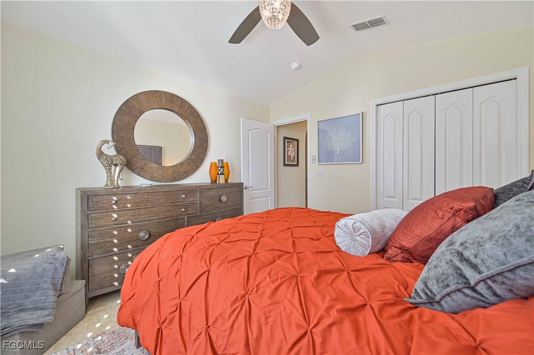 21593 Windham Run Estero, FL 33928 - Photo 32 of 49 a bedroom with a bed and a dresser