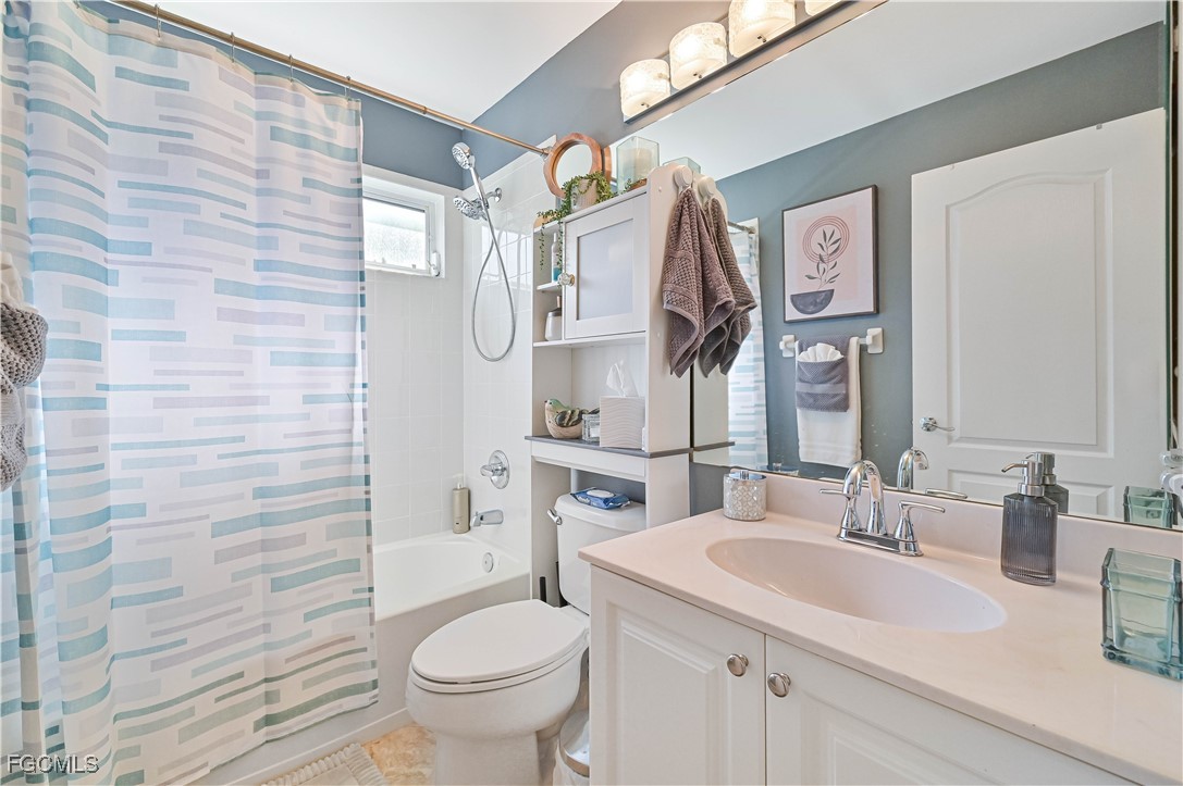 21593 Windham Run Estero, FL 33928 - Photo 33 of 49 a bathroom with a granite countertop sink toilet and shower