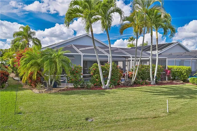 a view of a backyard with a patio table and chairs
