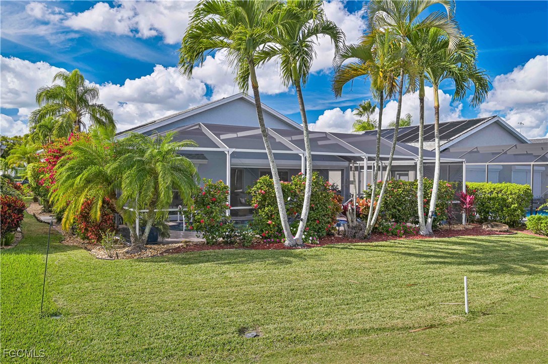 21593 Windham Run Estero, FL 33928 - Photo 35 of 49 a view of a backyard with a patio table and chairs