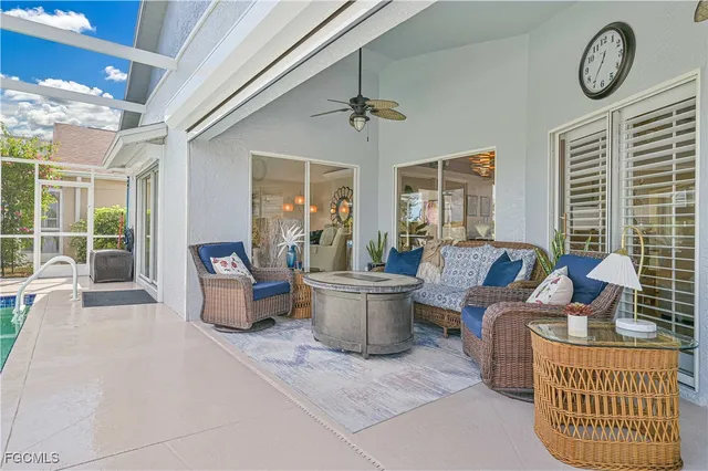 a living room with furniture a window and a clock