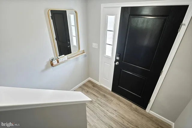 a view of a room with wooden floor