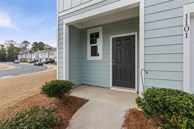 a couple of potted plants in front of door