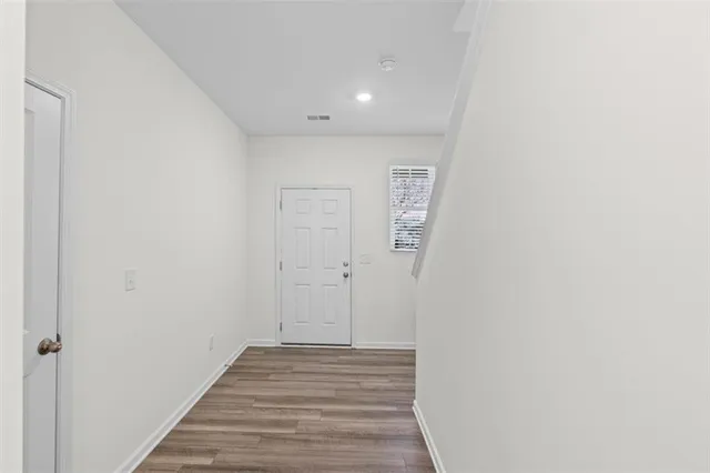 a view of a hallway with wooden floor
