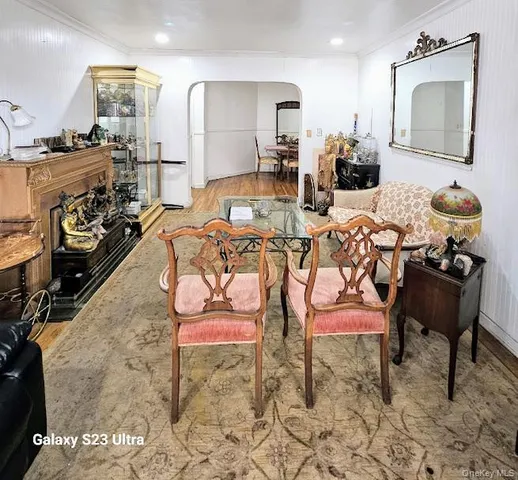 a living room with furniture a rug and white walls