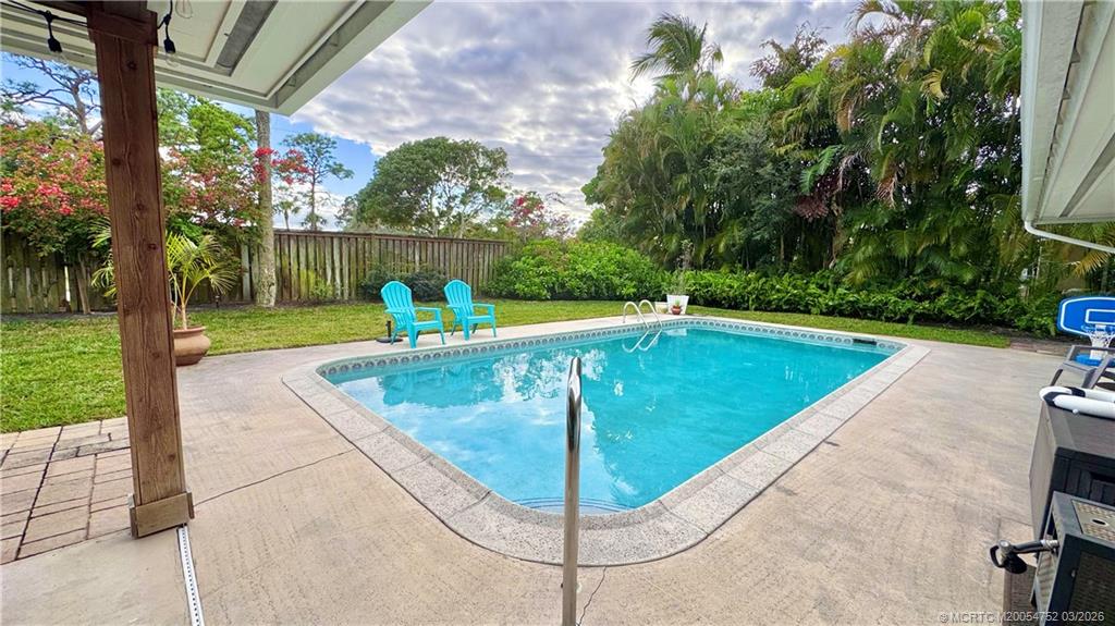 323 Southwest Ridge Lane Stuart, FL 34994 - Photo 20 of 22 a view of a swimming pool with a patio