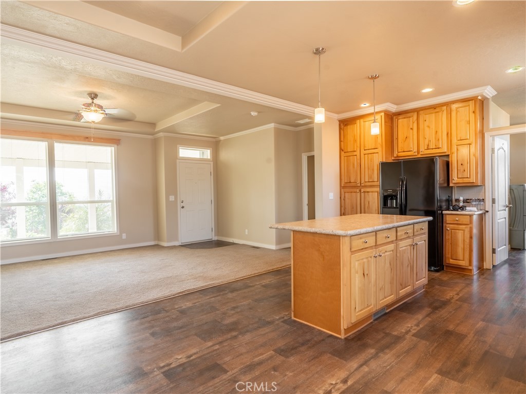 5548 Newland Road Paradise, CA 95969 - Photo 4 of 23 a large kitchen with stainless steel appliances granite countertop a stove a sink a refrigerator and white cabinets with wooden floor