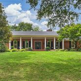 front view of a brick house with a yard