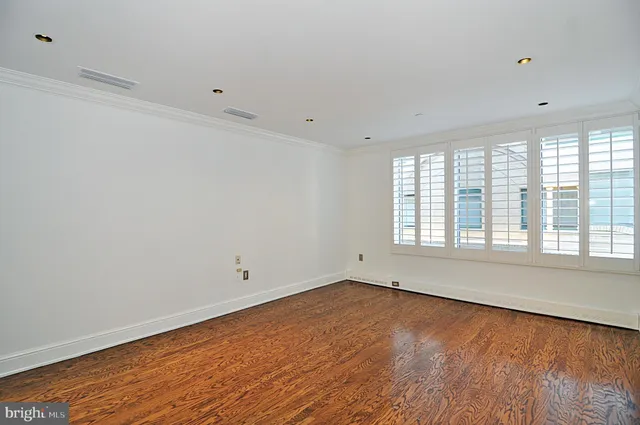 a bathroom with a granite countertop sink a mirror and a shower