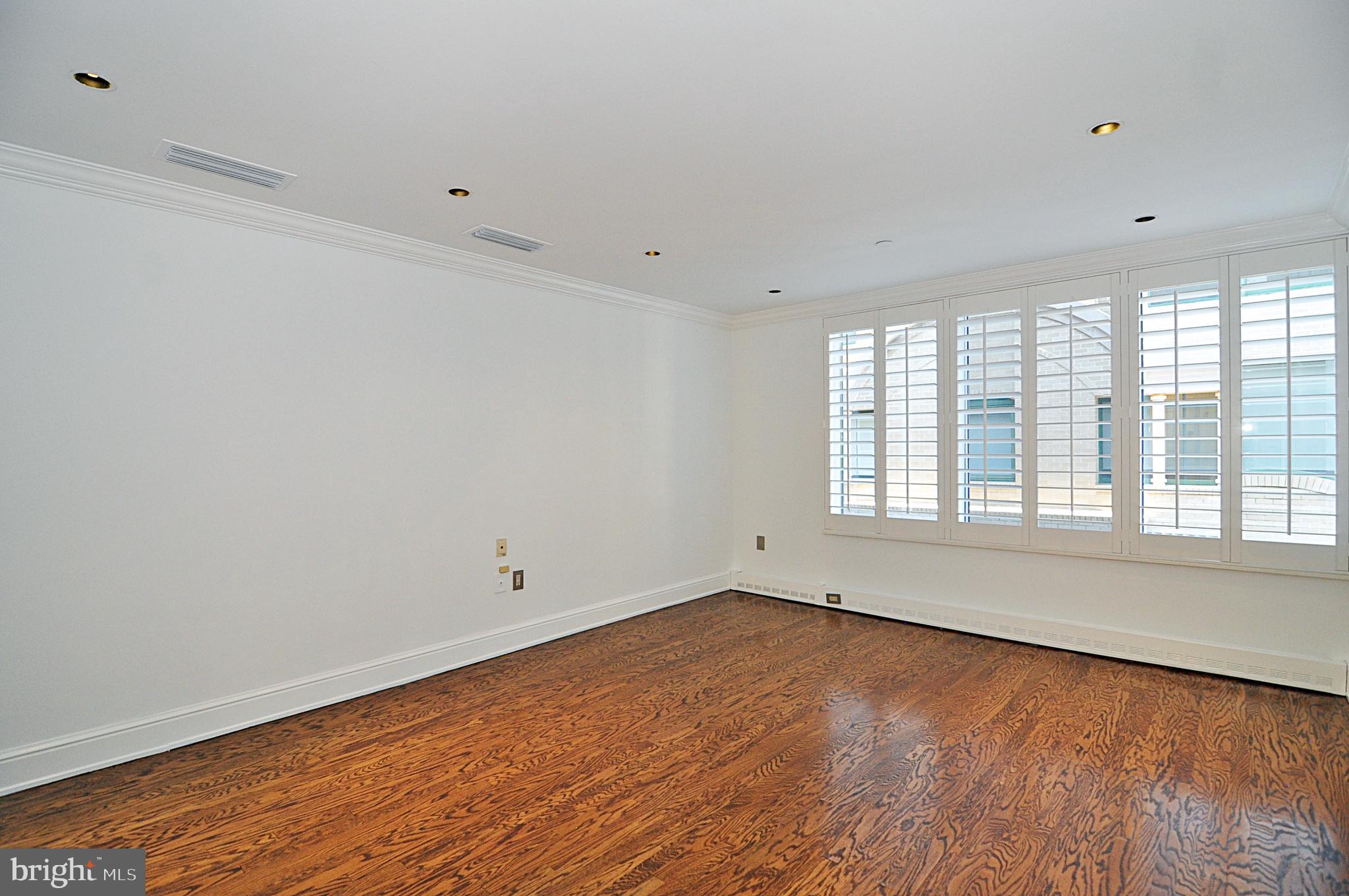 3030 K Street Northwest, Unit 204 Washington, DC 20007 - Photo 15 of 34 wooden floor in an empty room with a window