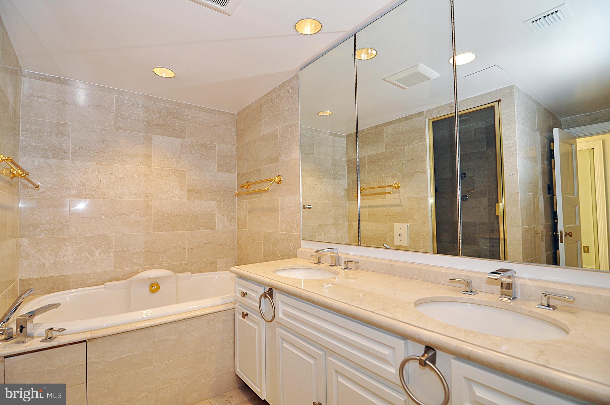 3030 K Street Northwest, Unit 204 Washington, DC 20007 - Photo 17 of 34 a bathroom with a tub sink double vanity and mirrors