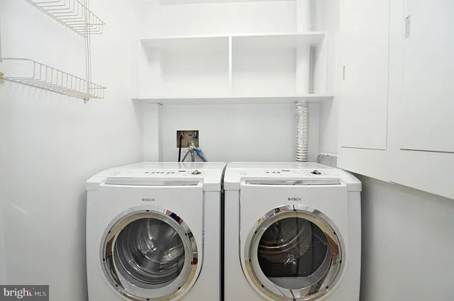 a bathroom with a toilet sink vanity and mirror