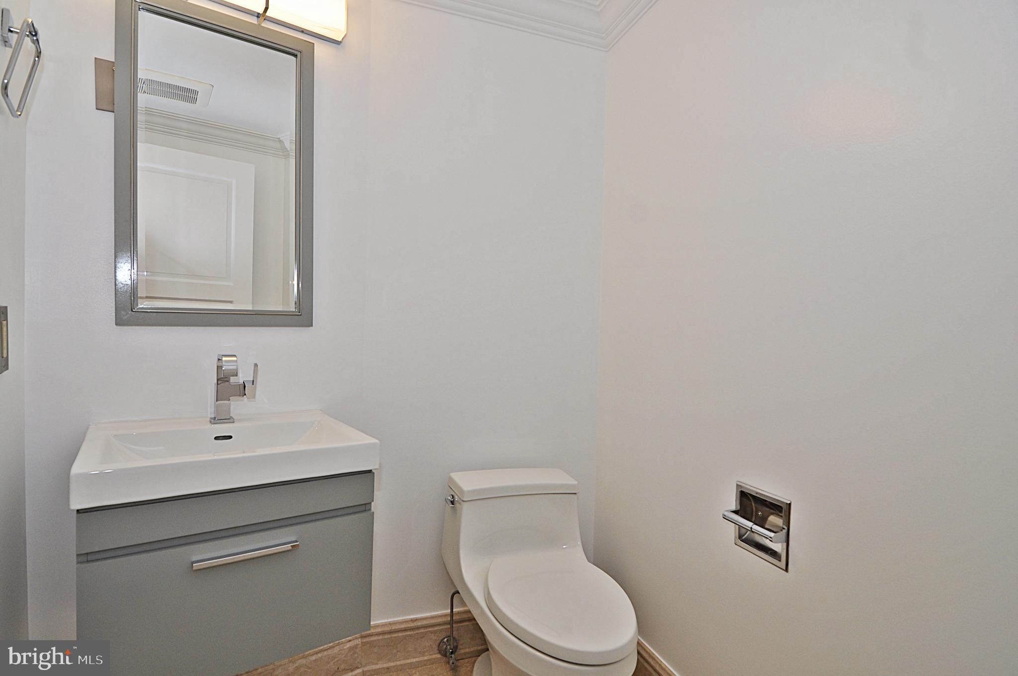 3030 K Street Northwest, Unit 204 Washington, DC 20007 - Photo 23 of 34 a bathroom with a toilet sink vanity and mirror