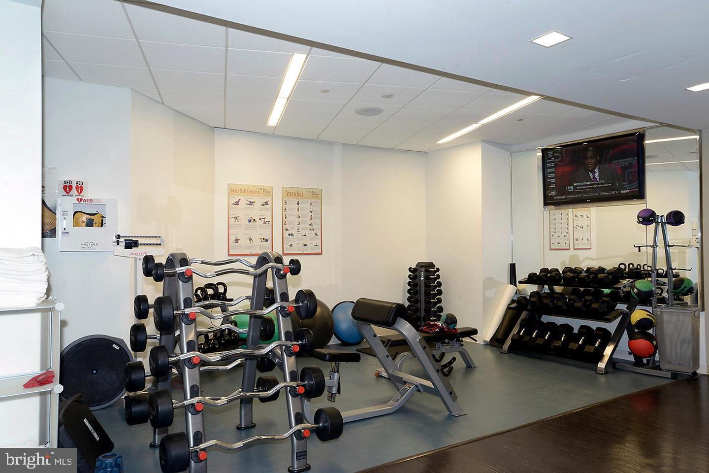3030 K Street Northwest, Unit 204 Washington, DC 20007 - Photo 28 of 34 a room with gym equipment and a flat screen tv