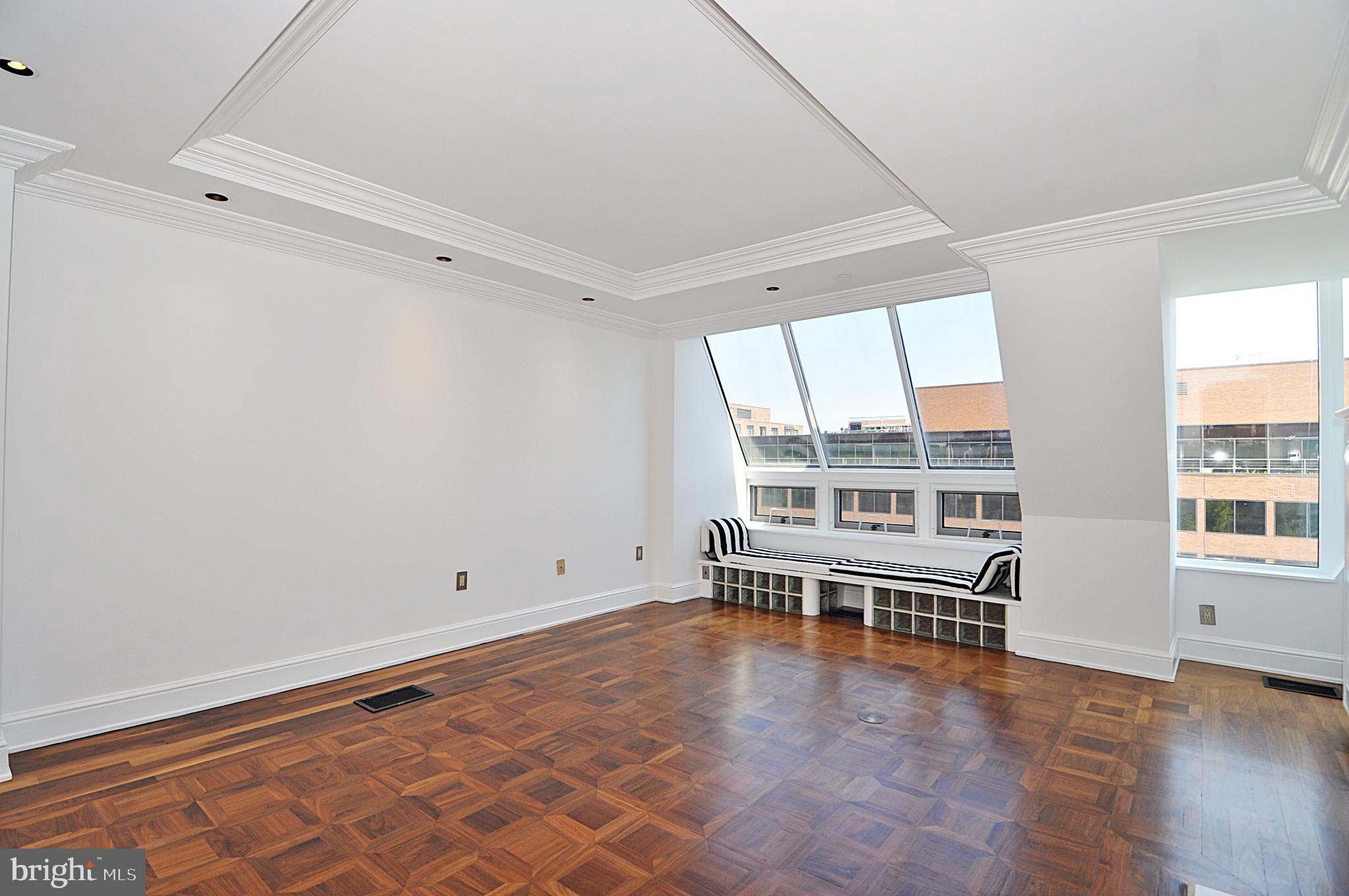 3030 K Street Northwest, Unit 204 Washington, DC 20007 - Photo 3 of 34 an empty room with wooden floor and windows