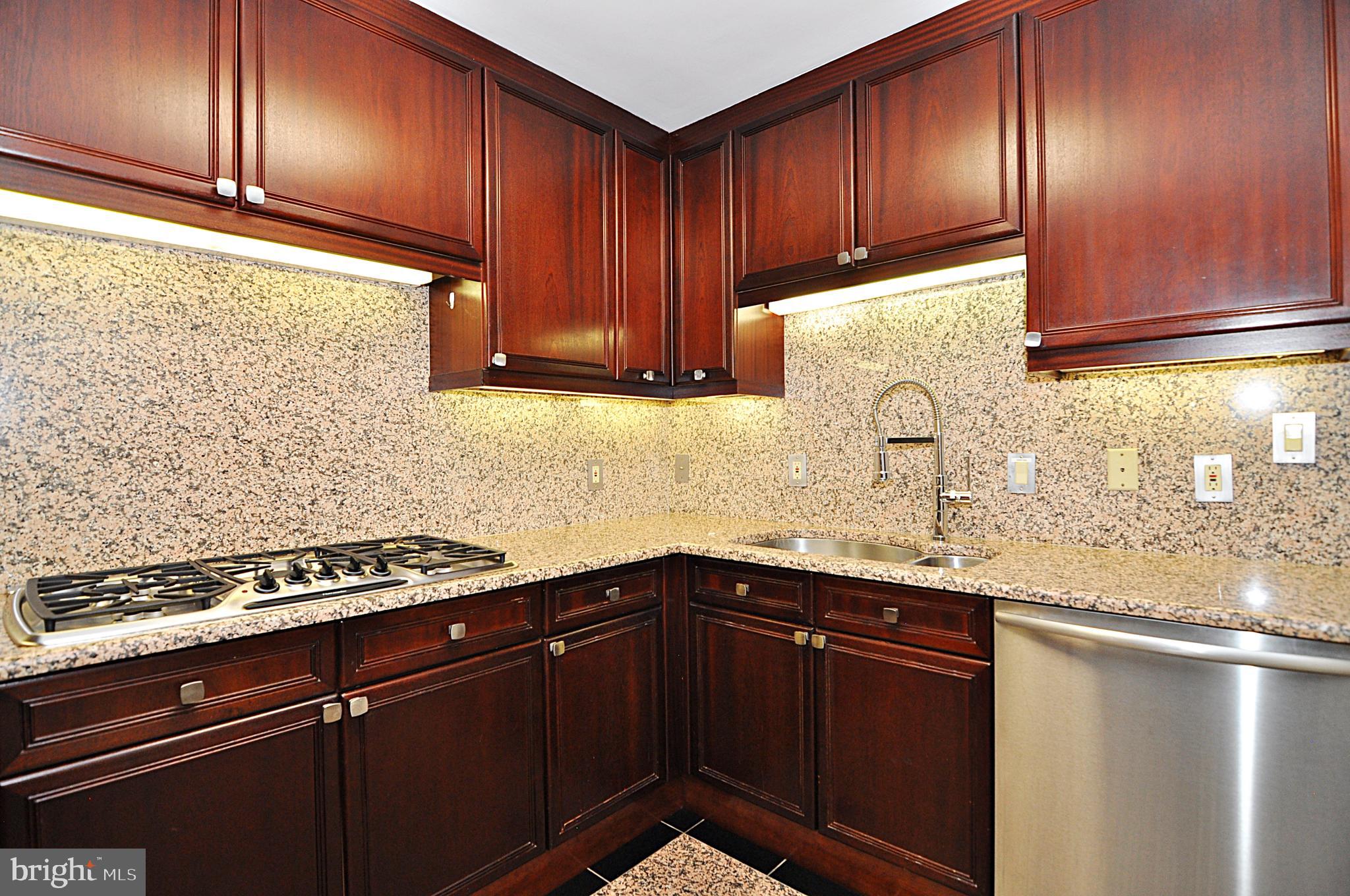 3030 K Street Northwest, Unit 204 Washington, DC 20007 - Photo 8 of 34 a kitchen with granite countertop cabinets and window