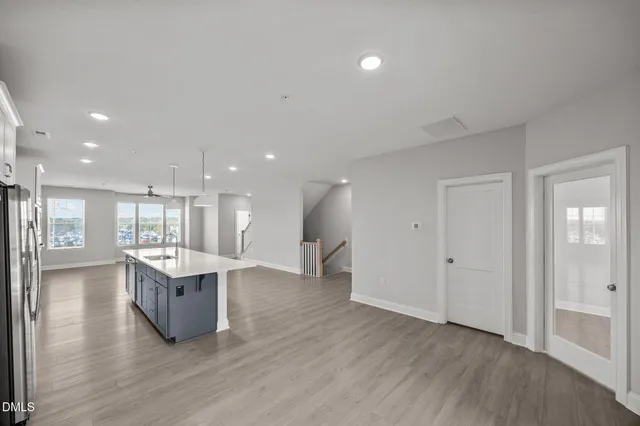 a large kitchen with a lot of counter top space and stainless steel appliances