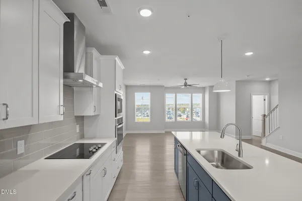 a kitchen with granite countertop a sink and a stove top oven