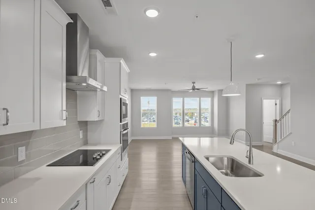 a kitchen with granite countertop a sink and a stove top oven