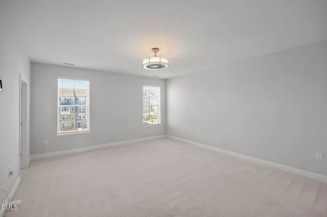 a view of empty room with windows