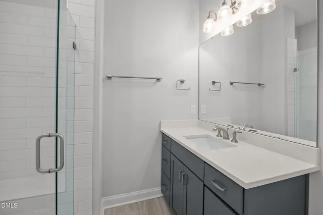 a bathroom with a sink vanity and a mirror