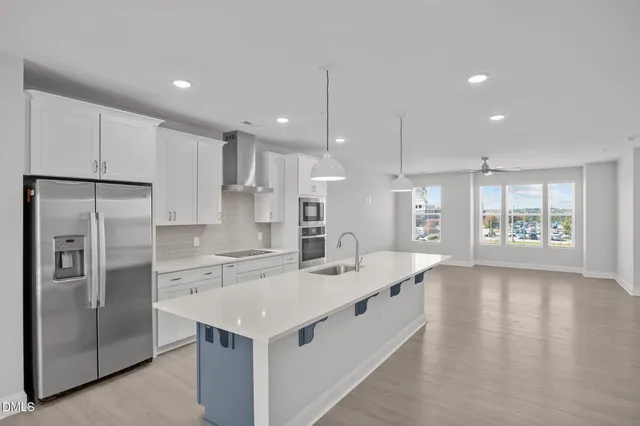 a kitchen with a sink a counter top stainless steel appliances and cabinets