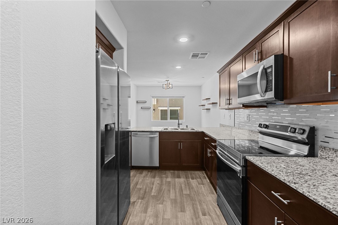 12367 Indigo Montage Road, Unit 3 Las Vegas, NV 89183 - Photo 4 of 33 This sleek kitchen features modern appliances and ample counter space for culinary endeavors.