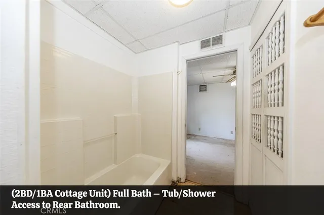 a view of a room with window and ceiling fan