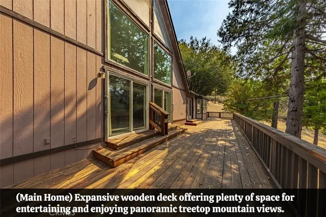 a view of a balcony with wooden floor and fence