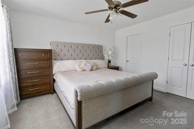 a bedroom with a bed and cabinet