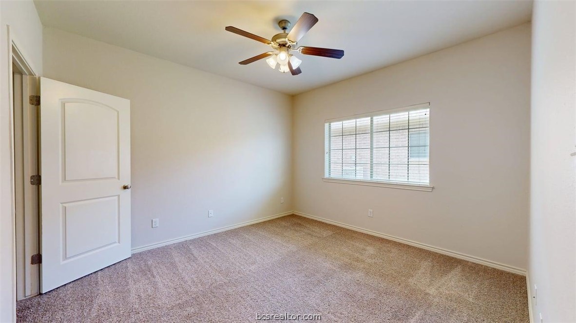 4453-4455 Reveille Road College Station, TX 77845 - Photo 33 of 37 an empty room with windows and ceiling fan