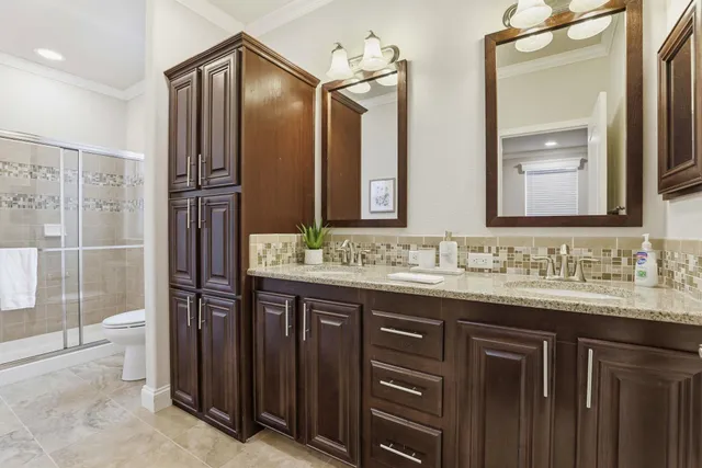 a bathroom with a granite countertop sink mirror and double