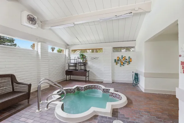 a living room with furniture and flowers