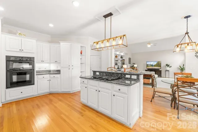 a bedroom with a bed and a large window with the outer view