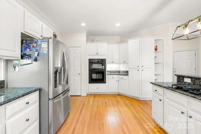 a kitchen with stainless steel appliances a refrigerator sink and microwave