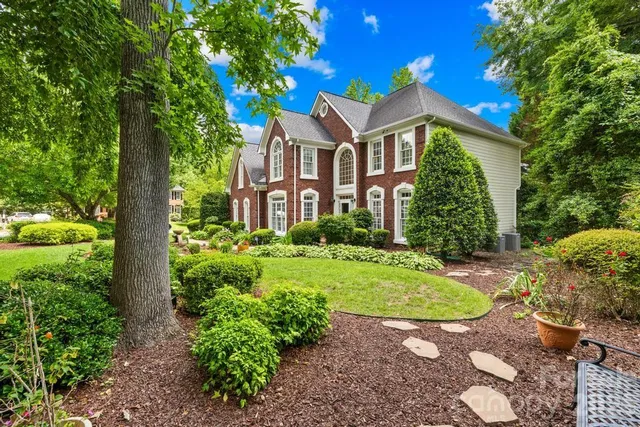 a front view of a house with a garden