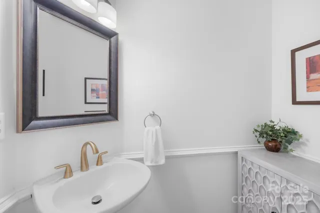 a bathroom with a sink a mirror and a window