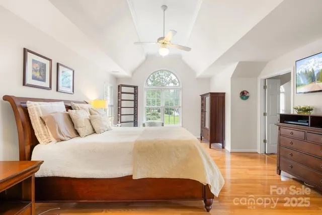 a bedroom with a large bed and a large window