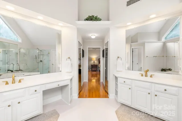 a spacious bathroom with a double vanity sink shower and a mirror