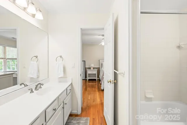 a en suite bathroom with a sink double vanity and a mirror