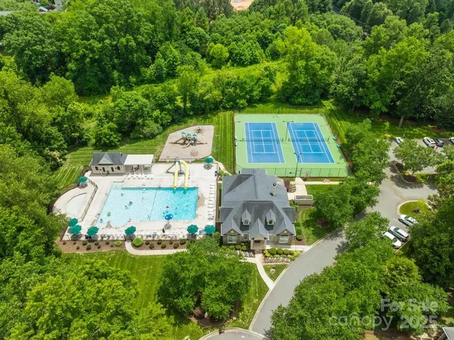 an aerial view of a house with pool yard and outdoor seating